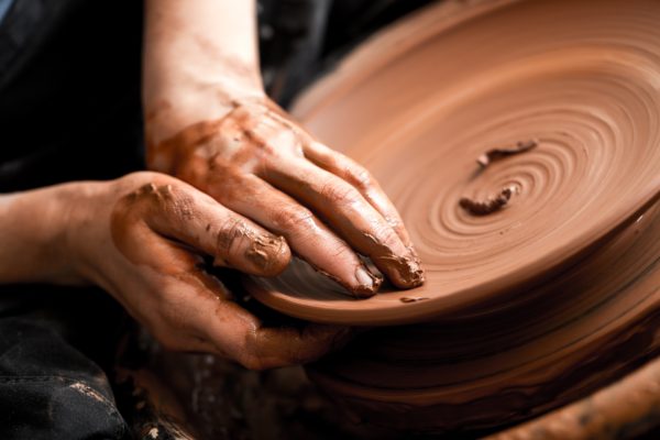 Hands crafting pottery