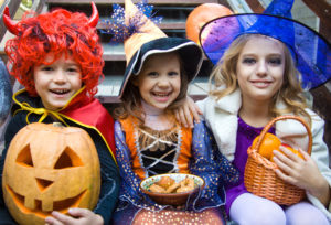 children in halloween costumes with pumpkin pigeon forge