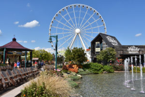 The wheel at The Island is visible behind some fountains and Ole Smoky Moonshine Co. 