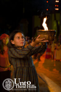 Unto These Hills Outdoor Drama: Little Girl holding a bowl with a flame inside 